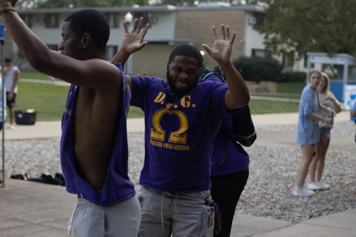 Members of the omega psi phi fraternity “strolling” to wipe me down by Booise on Eastern Illinois University Campus on Monday Evening