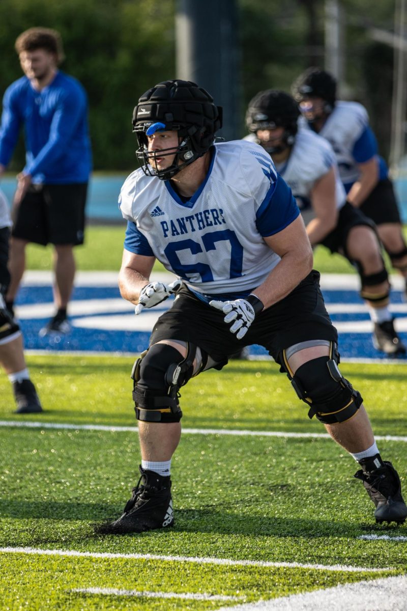Chad Strickland, a senior exercise science major, performs offensive line drills at OBrien Field on Eastern Illinois University Campus Monday Evening