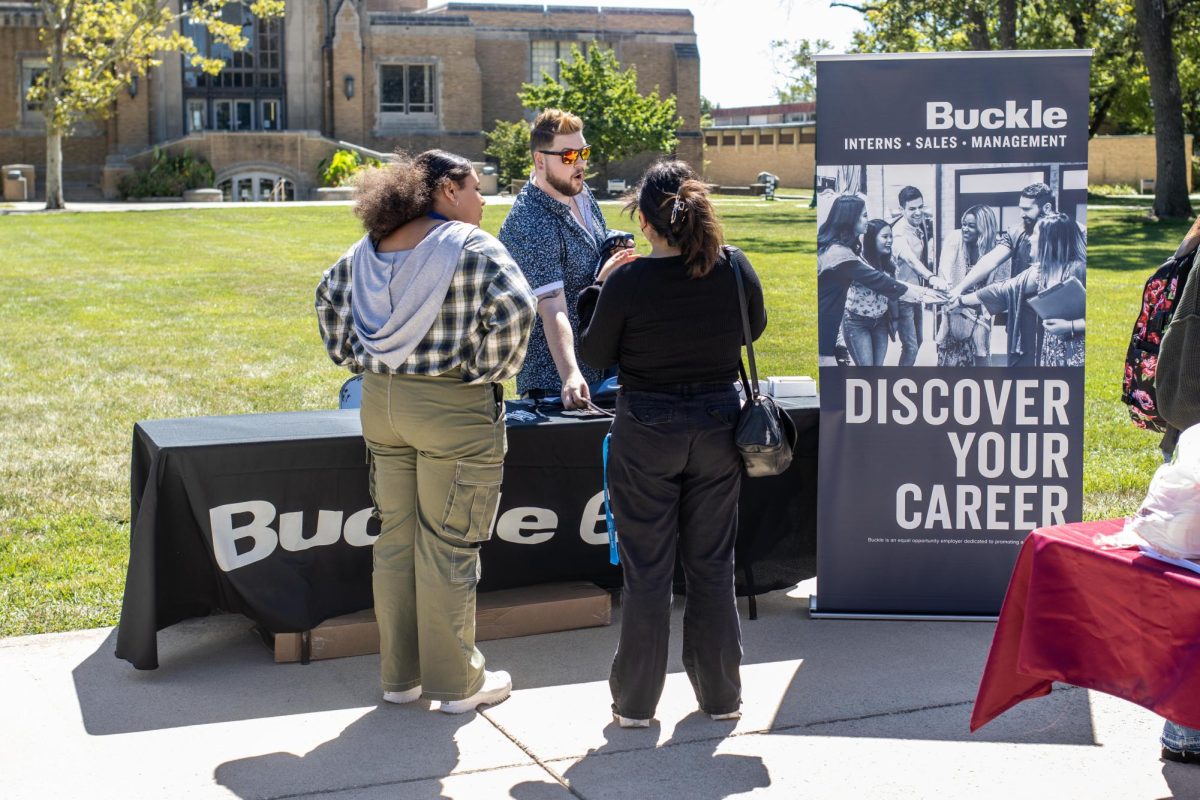 On the library quad, Eastern Illinois University students and a corporate representative talk about current opportunities and available internships at the job fair Thursday afternoon.