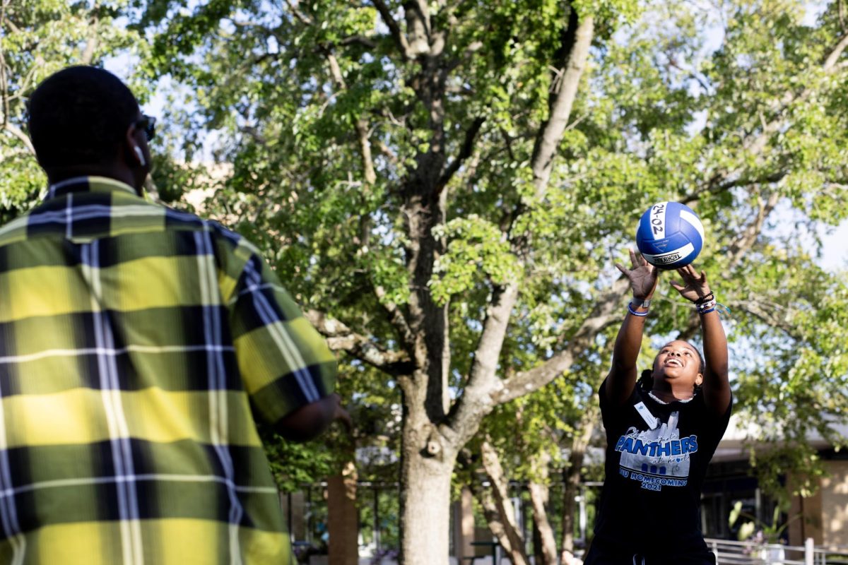 Shay Edmond, a senior sociology major, plays volleyball in the South Quad as one of the activities for Black Student Unions Kickin It On the Quad field day event Wednesday evening.