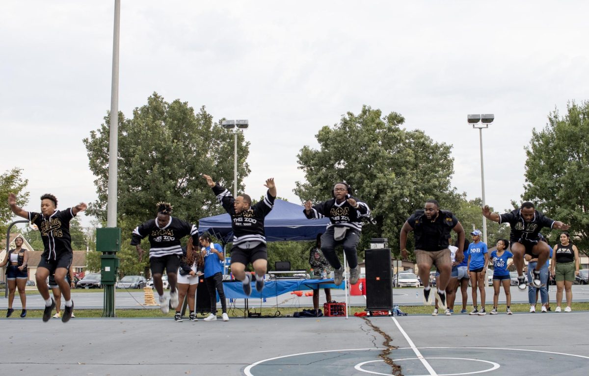 Members of Alpha Psi Alpha Fraternity, Inc. stroll at the annual Meet the Greeks event at the Lawson Hall basketball courts on Saturday afternoon.