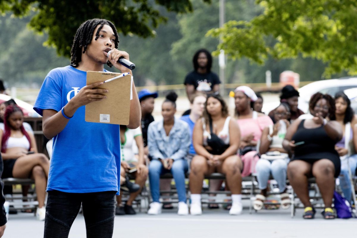 A member of Phi Beta Sigma Fraternity, Inc. Marshone Gordon, a junior TV and video production major, emcees and announces the next group up to perform during the Meet The Greeks event Saturday evening.