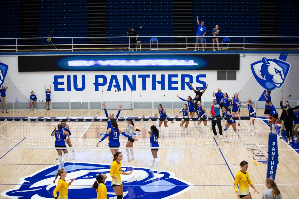 The EIU volleyball team celebrate their 3-2 win at their home game against the Valparaiso Beacons Friday night in Lantz Arena.