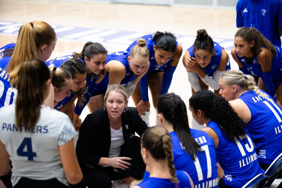 The EIU volleyball team huddle in and listen to their coach Sara Thomas during a timeout at their game vs. Valparaiso. Friday night in Lantz Arena.