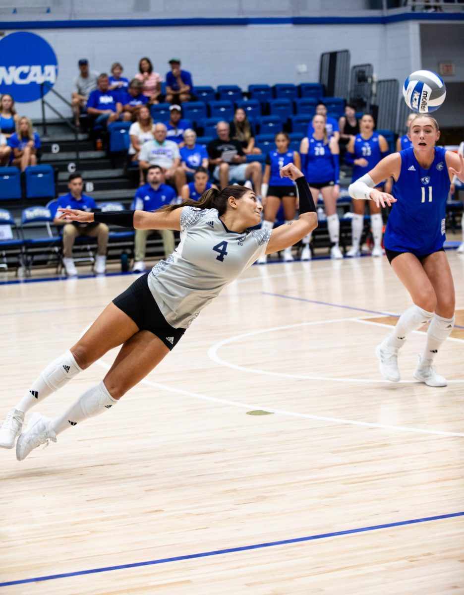 Senior Christina Martinez Mundo (4) attempts to defend the ball at EIUs volleyball game against Valparaiso. The Panthers won 3-2 against the Beacons Friday night in Lantz Arena.