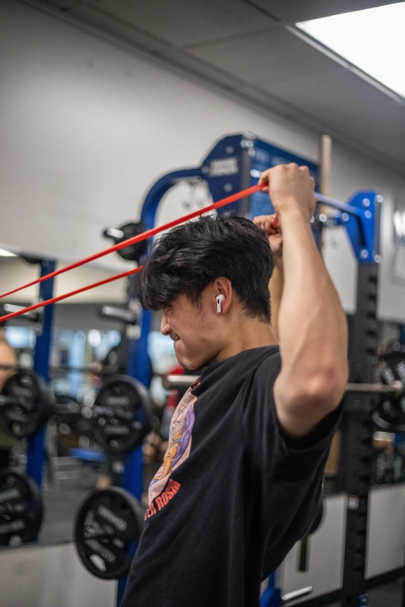 Kris Hanratanakool, a nutrition dietetic graduate student, warms up before EIU lifts workout session at the recreation center on Eastern Illinois University campus Friday afternoon