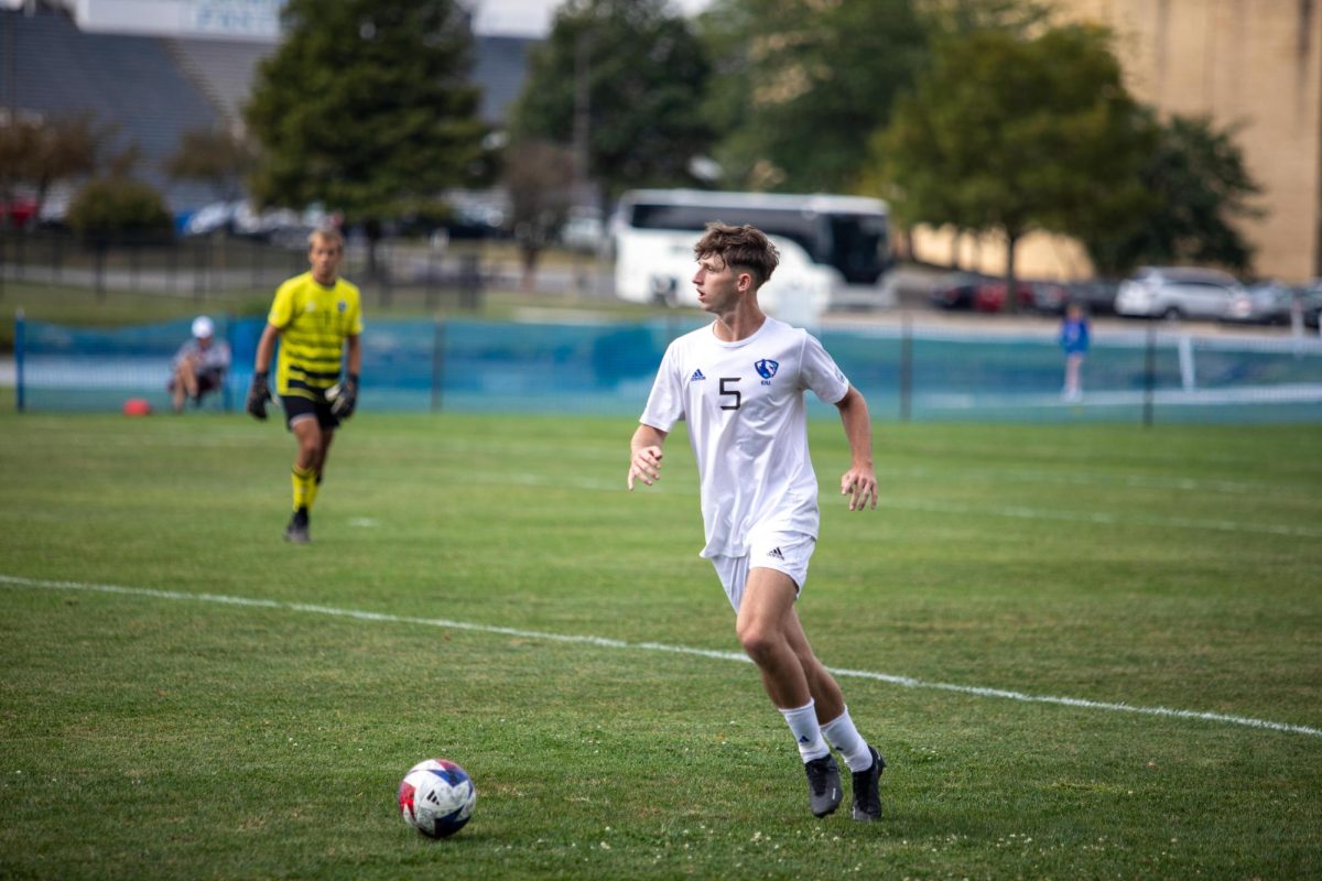 Jake McConnery, a freshman business major, dribbles the ball up field at Lakeside Field Saturday afternoon.