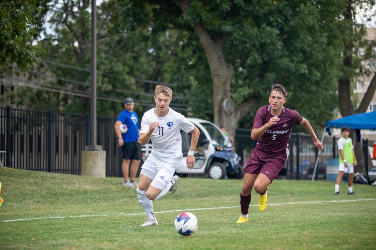 Jeffery Rinker II, a freshman, dribbles the ball away from Bellarmine player at Lakeside Field Saturday afternoon
