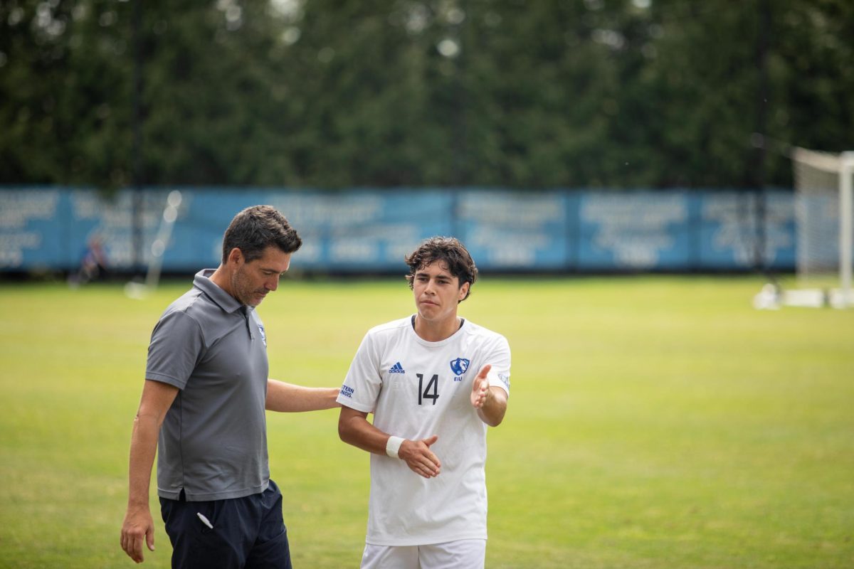 Kyle Kimberling, a freshman business marketing major, talks with head coach Josh Oakley before halftime at Lakeside Field Saturday afternoon