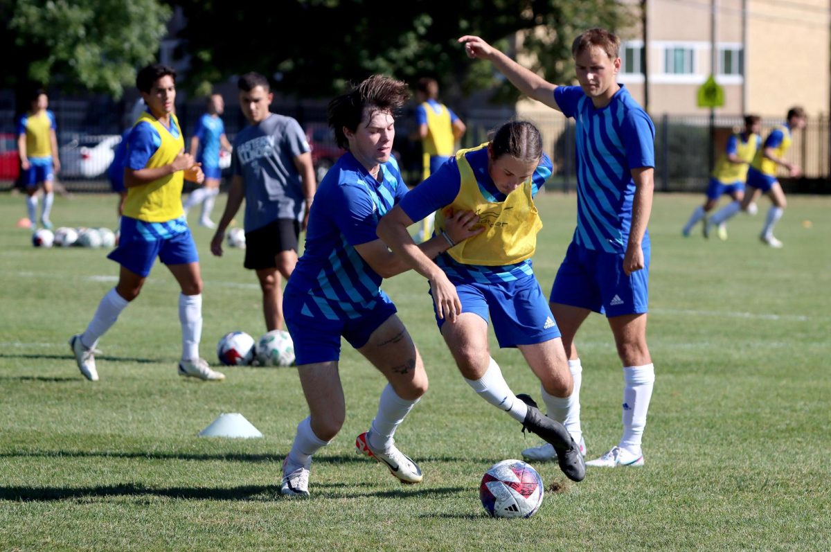 Forward Casey Welage (8) and midfielder Jesse da Costa (35) battle for the ball at mens soccer practice Lakeside Field on Thursday.