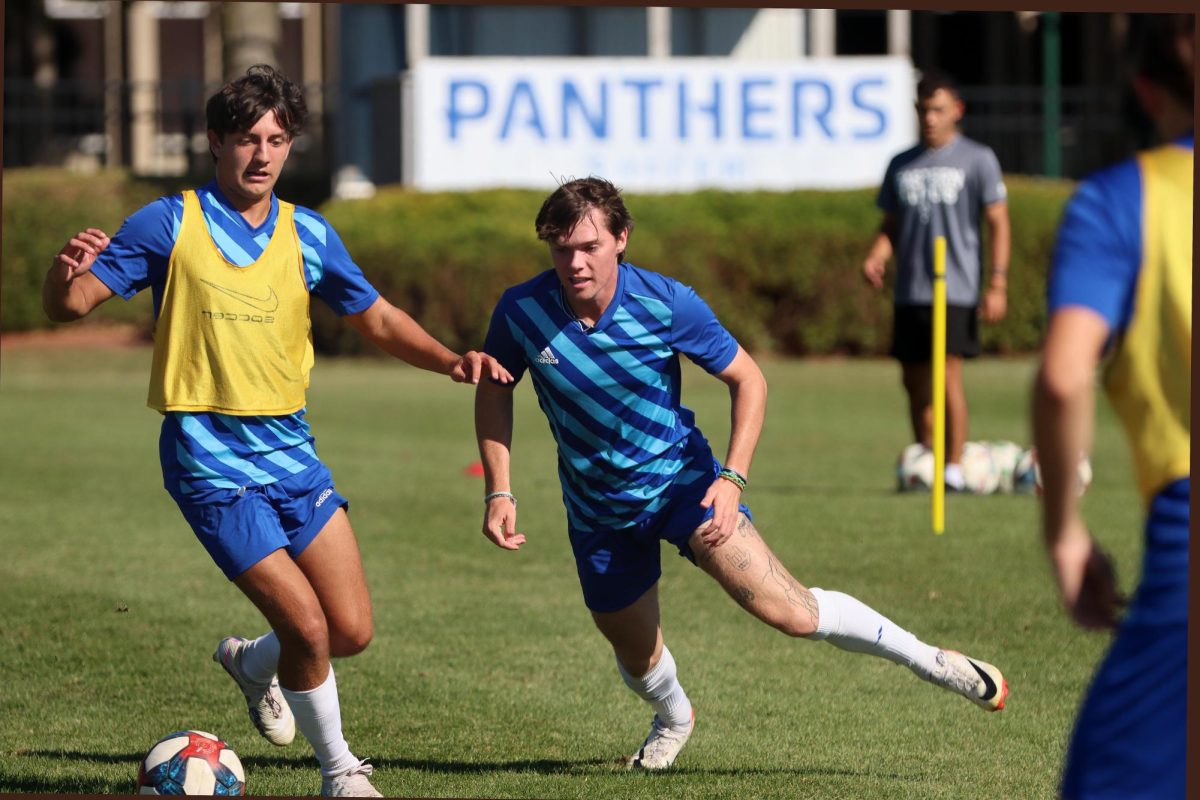 Forward Casey Welage (8) and midfielder Jake Pollock (25) chase after the ball at mens soccer practice at Lakeside Field on Thursday.