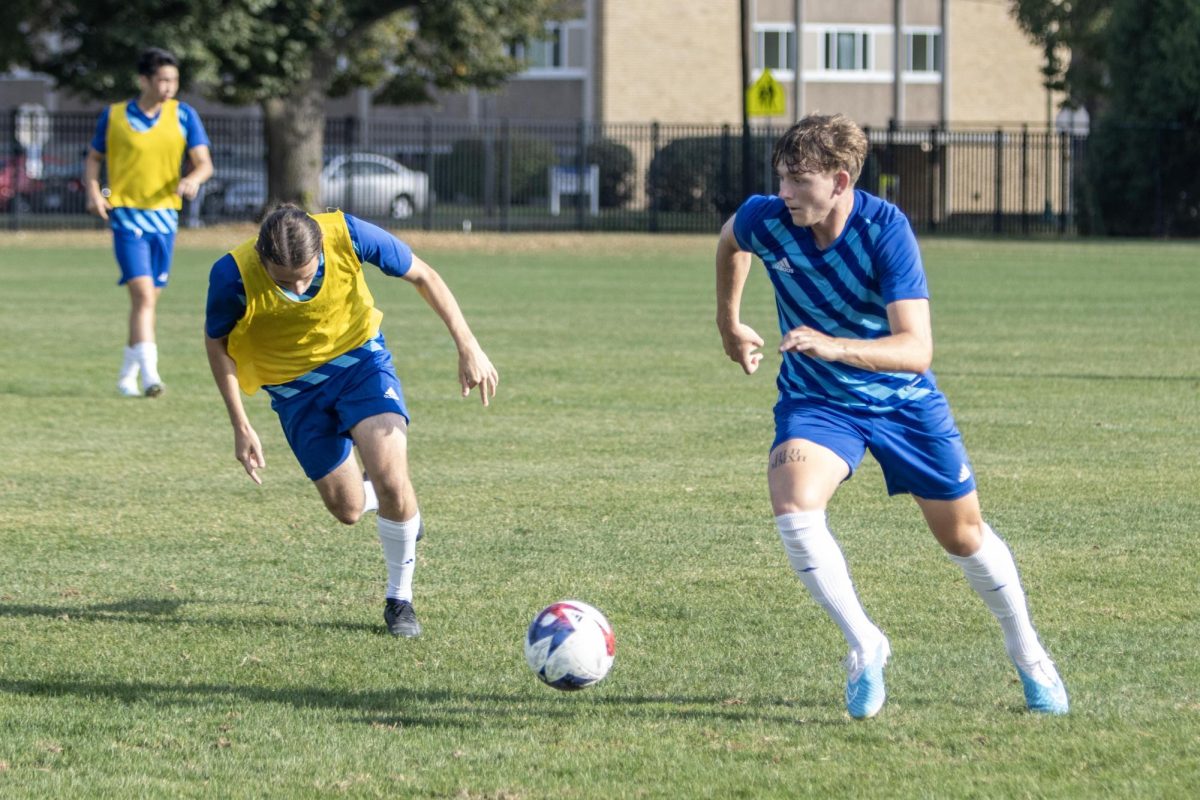 Freshman defender Lance Somerfield dribbles past senior midfielder Jesse da Costa.