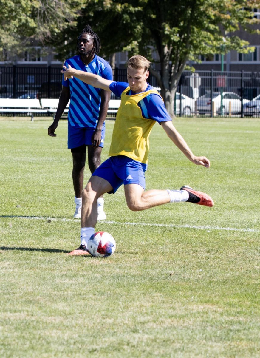 Forward Sam Eccles shoots towards the goal at Lakeside Field.