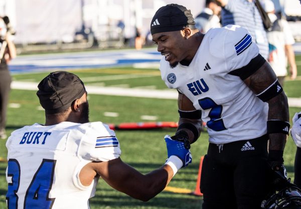 Mark Aitken (2) congratulates his teammate NiJhay Burt (34) on his interception at the EIU vs. Indiana State game Thursday night.