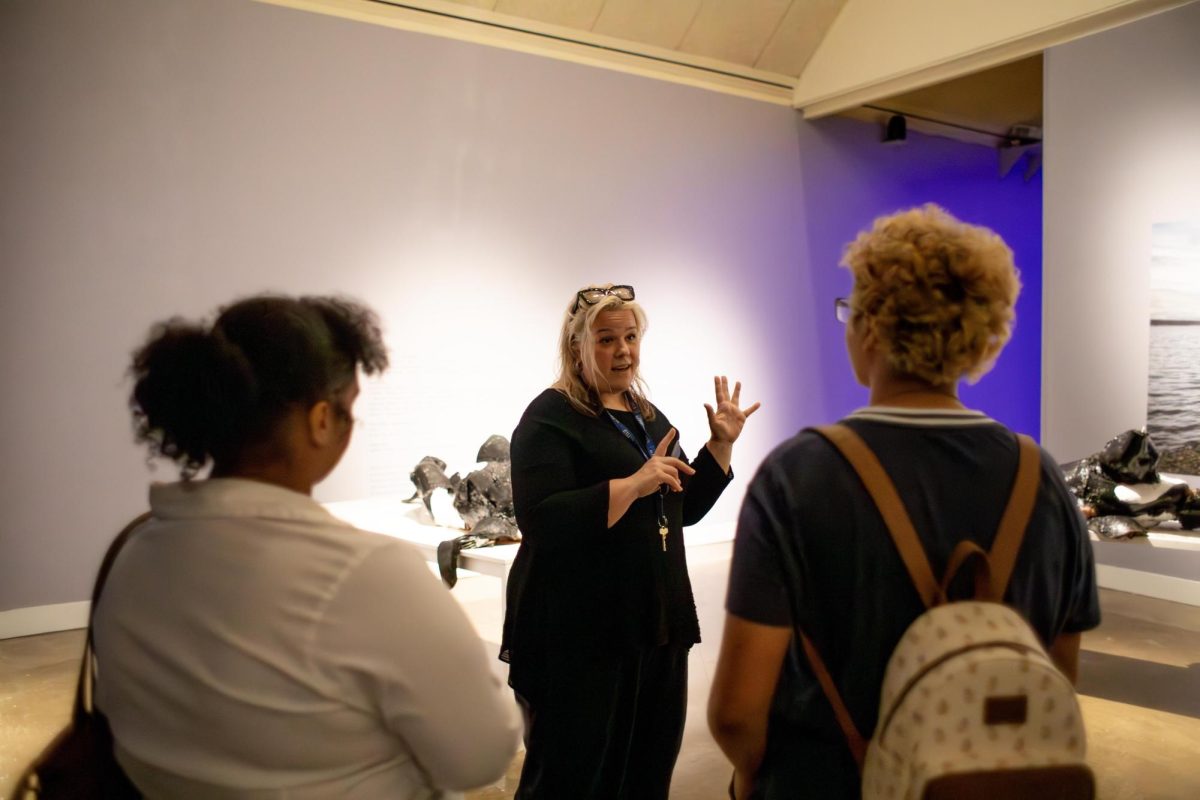 Director of the Tarble Arts Center Jennifer Seas walks students through the new Who Speaks for the Oceans? exhibition on Monday evening.