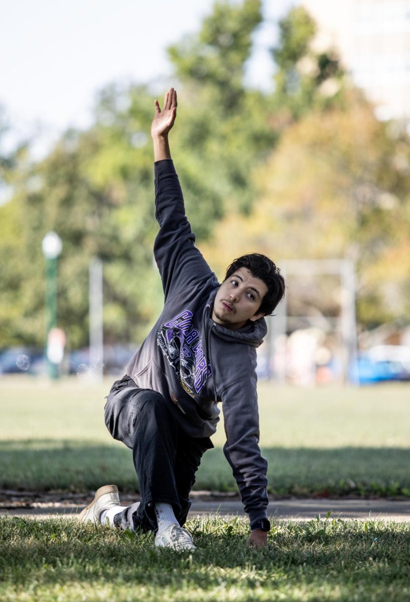 Oscar Aguilar, a senior graphic design major, follows directions for different yoga poses.