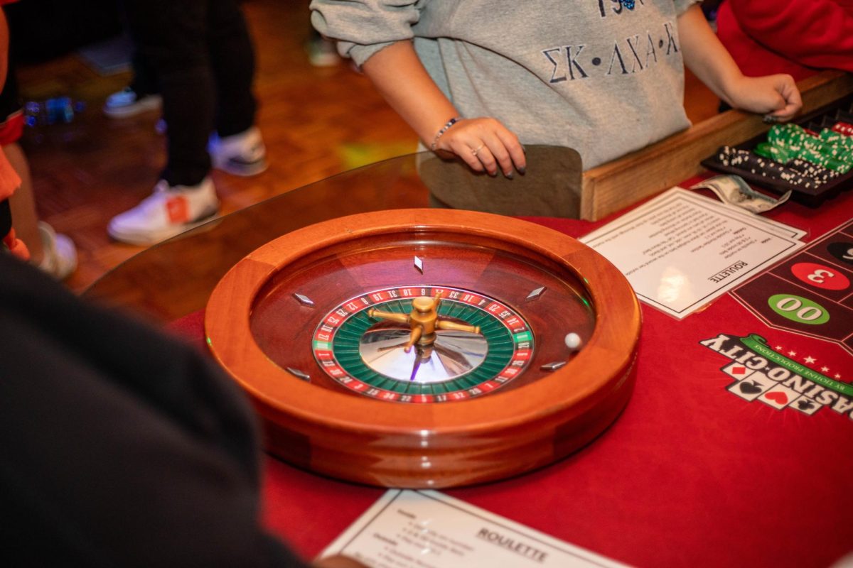 Casino Night dealer spins roulette wheel at Martin Luther King Jr. University Union Grand Ballroom Thursday evening.