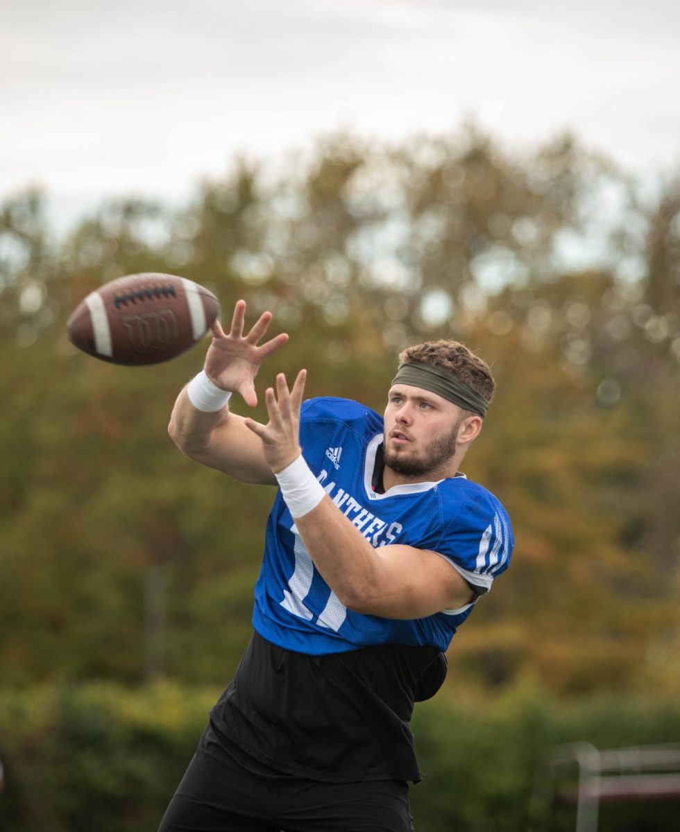 Anthony Manaves, a junior tight end practices catching the football with a teammate at OBrien Field wednesday afternoon.