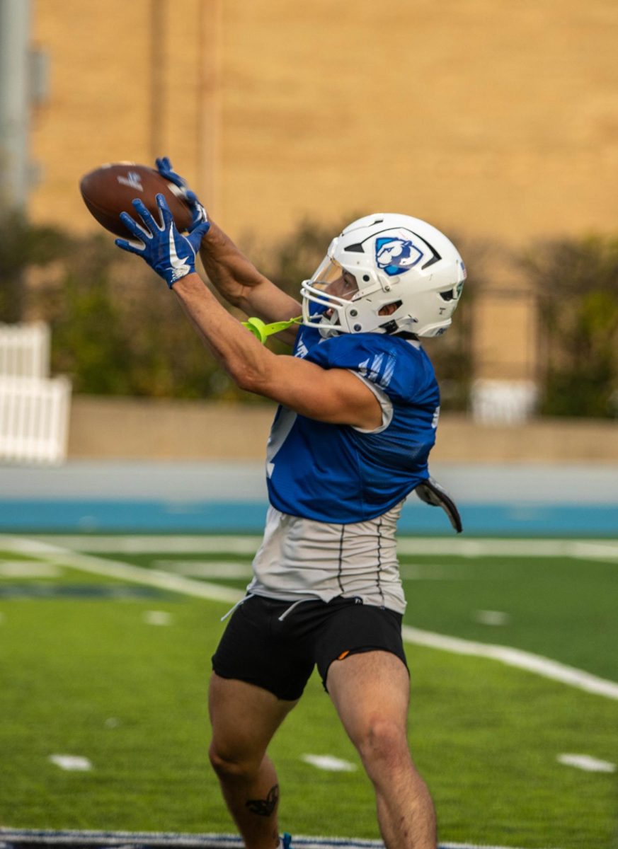 Eli Mirza, a junior wide receiver catches a pass during practice at OBrien Field wednesday afternoon.