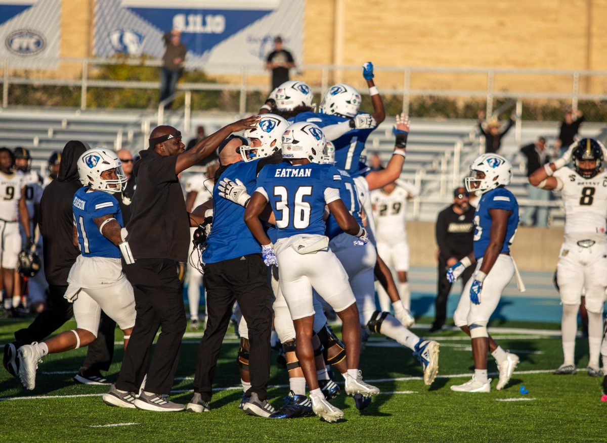Eastern+football+players+and+coaches+celebrate+after+quarterback+Pierce+Holley+scores+in+overtime+to+win+the+game+against+Bryant+University+Bulldogs+at+O%E2%80%98Brien+Field+saturday+afternoon.+The+panthers+defeated+the+bulldogs+25-24+in+overtime.
