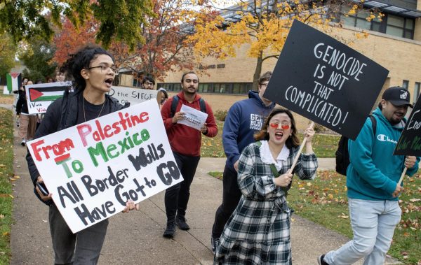 Jason Farias, a senior history education major, leads a group throughout campus during a student walkout demanding a free Palestine at the Mellin Steps in protest of the Israel genocide on Palestinian civilians Wednesday afternoon. Farias said there were around 100 other schools in the nation participating in the walk.