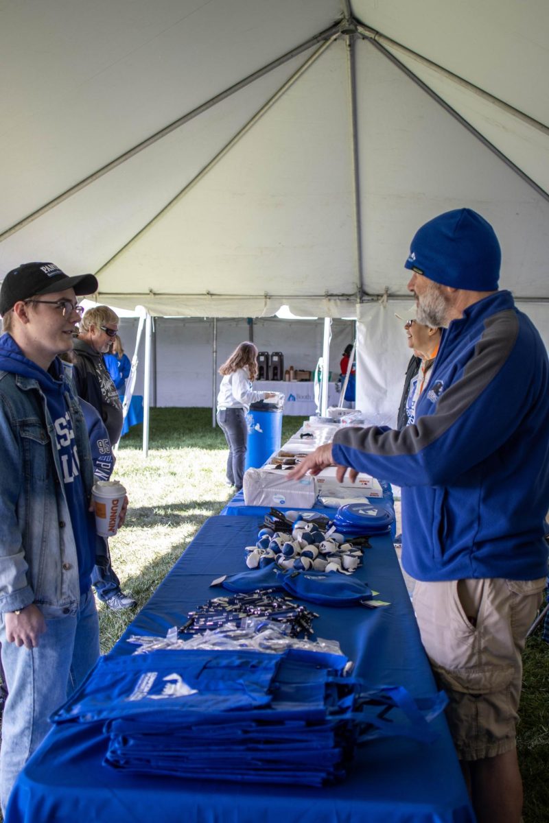 Eastern Staff give away merchandise and food to the public during Homecoming tailgate behind O‘Brien Field Saturday afternoon.