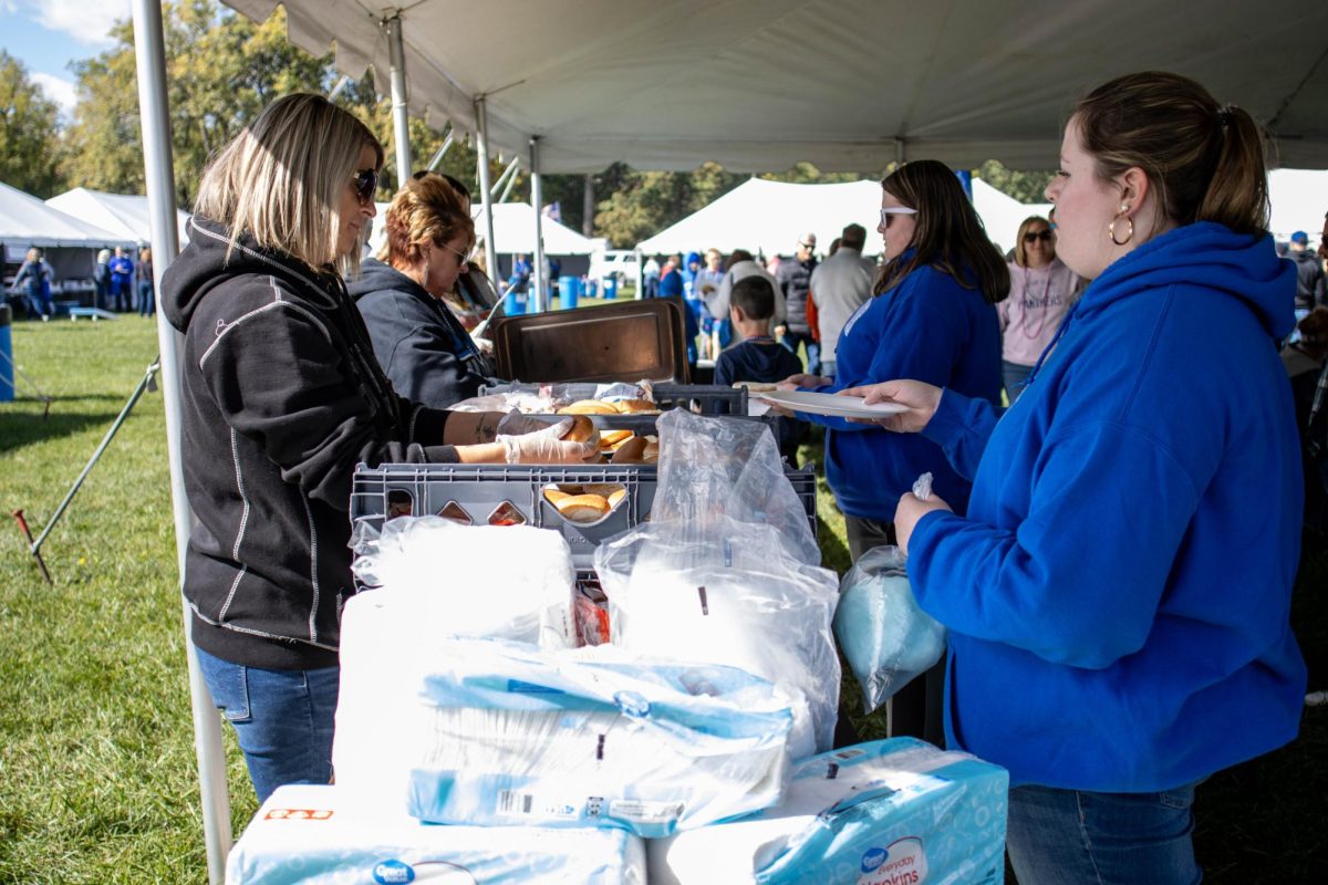 Eastern Staff and Students serve food to the public during Homecoming tailgate behind O‘Brien Field Saturday afternoon.