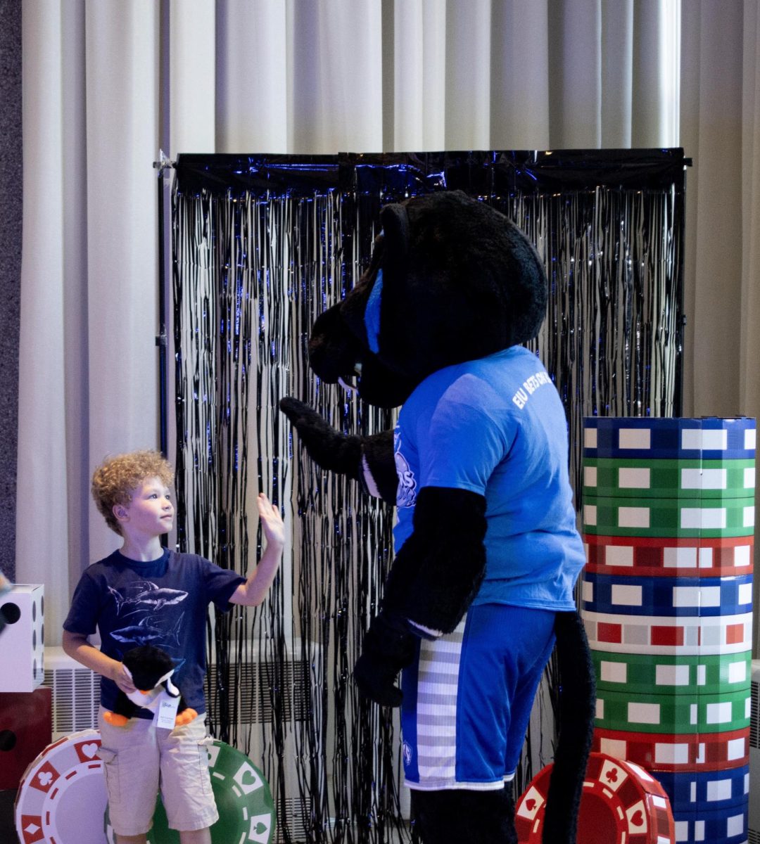 Billy the Panther high-fives kids who came to homecoming fun night on Tuesday.