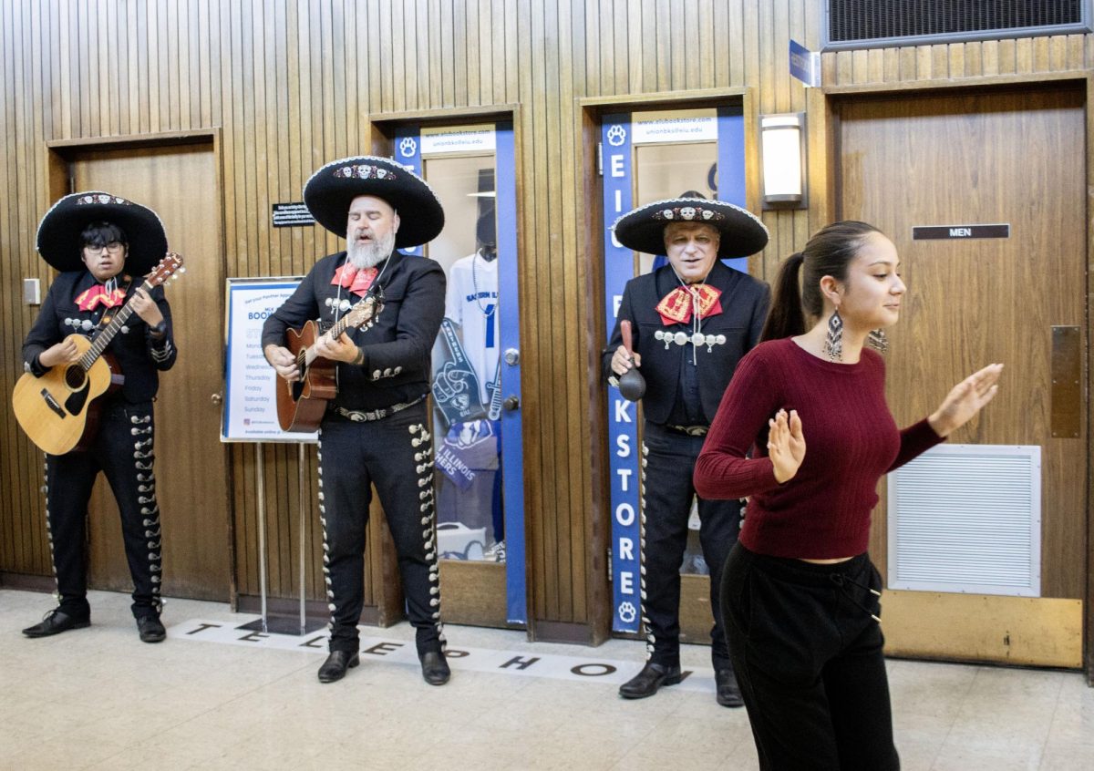 Kassandra Garcia, a human services graduate student, dances along to the music of Los Amigos band in the food court of Martin Luther King Jr. University Union.