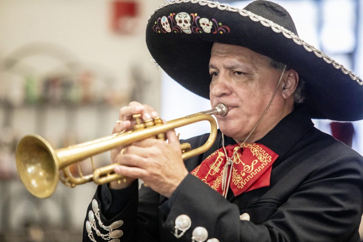Luis Trevino, the band leader of Los Amigos, plays trumpet and sings in South Quad Dining where students and faculty applaud for them. Trevino said it has been an adventure being able to travel with the band.