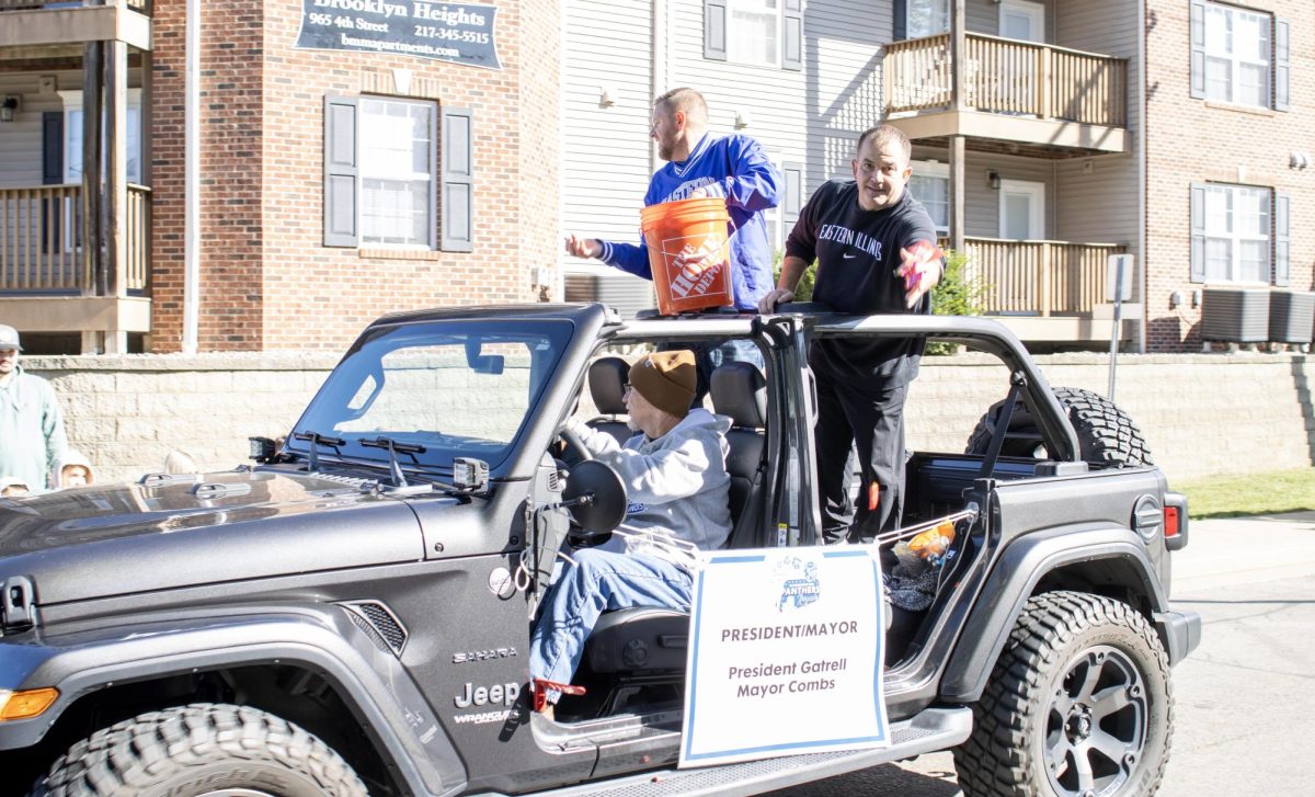 Eastern Illinois Universitys president Jay Gatrell and the city of Charlestons mayor, Brandon Combs, throw candy for people during EIUs homecoming parade Saturday morning.