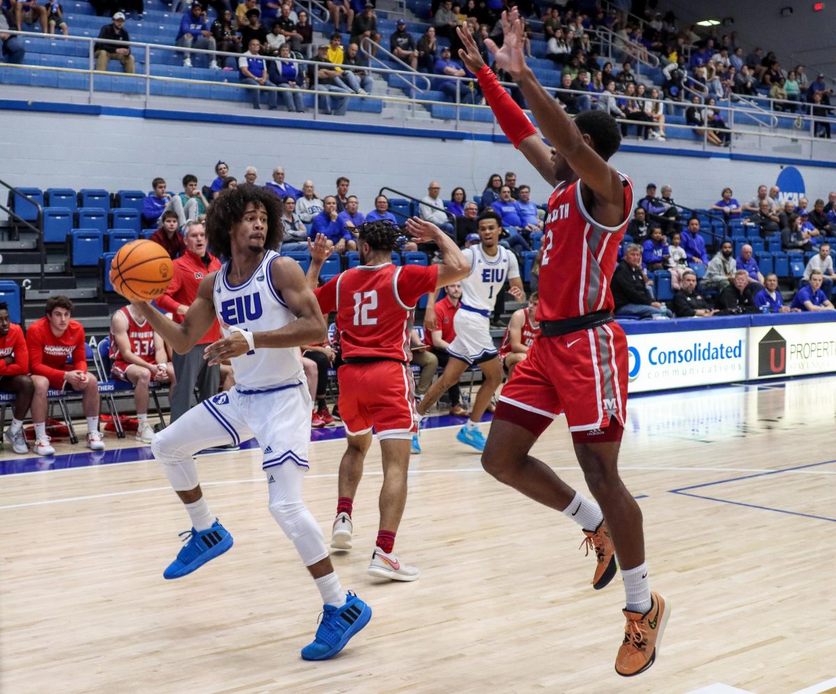 Freshman forward Isaiah Griffin looks for a pass while being pressured by Monmouth College junior guard Jordan Hill during Easterns home opener on Wednesday evening at Lantz Arena. Griffin scored five points, had two rebounds and was 2-6 on field goals.