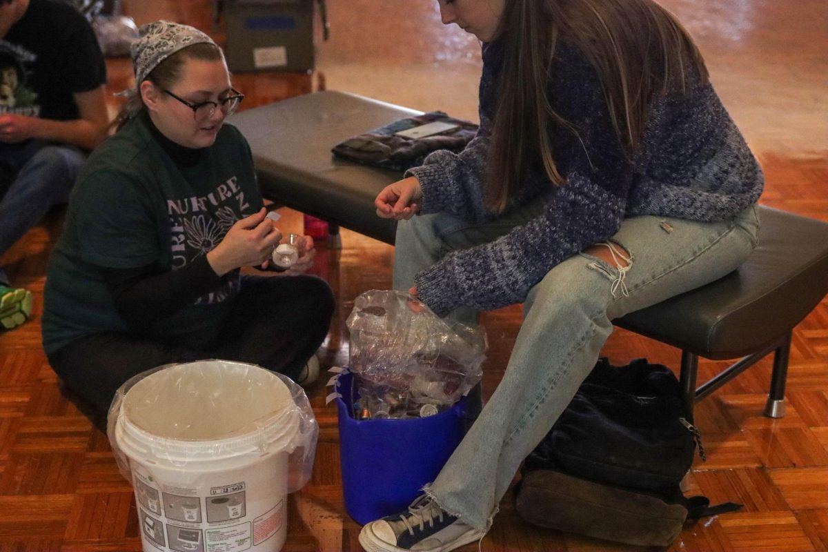 Eastern Illinois students sort through batteries to prepare for recycling during the Plug into Sustainability held at Grand Ballroom of Martin Luther King Jr. University Union on Tuesday afternoon.