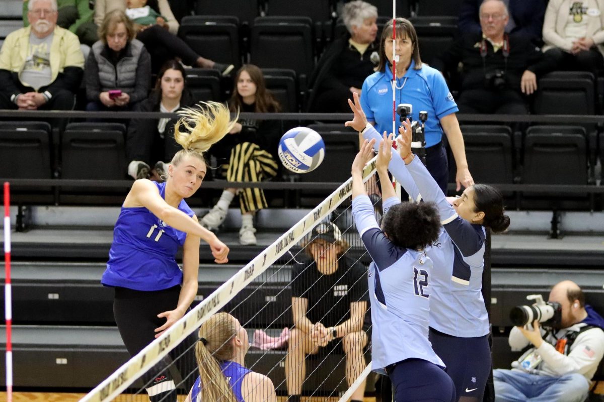 Junior outside hitter Kaitlyn Flynn, attempts to spike the ball over the net but is blocked by the Marquette University Golden Eagles. The Panthers were swept 3-0 for the first time this season. Flynn had seven kills and points.