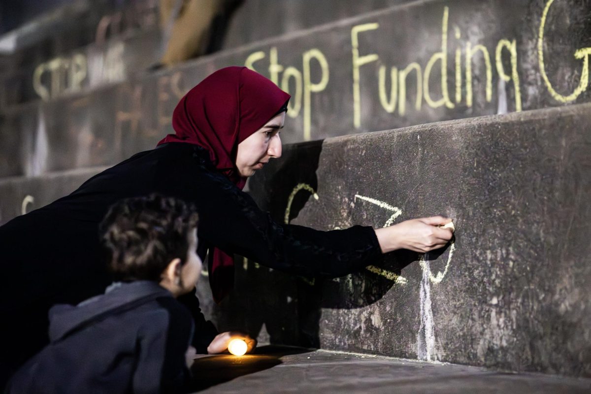 Esraa Jarrar writes, Save the kids in Gaza on the Mellin Steps at the vigil for the 4100 plus children that have died in Gaza. Jarrar said, I have four kids and thats what makes it harder on me to see children each day dying under their own homes. 