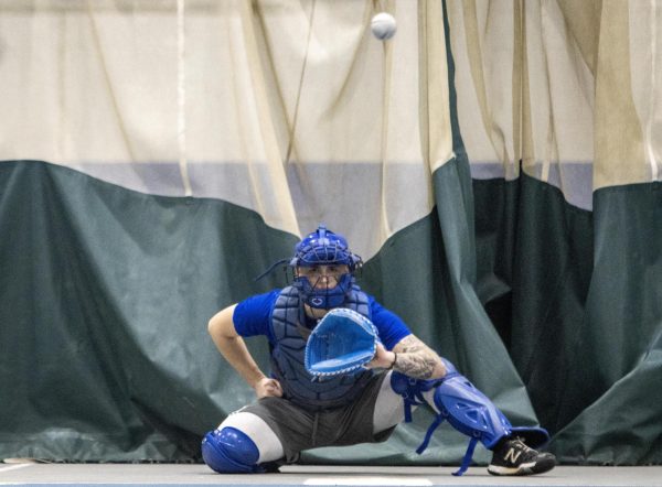 Senior right-handed pitcher Jonathon Hanscom catches during baseball practice in the Lantz Indoor Fieldhouse on Thursday evening.  Hanscom appeared in 19 games during the 2023 season and had 51 strikeouts in 52.1 innings of work on the mound. 