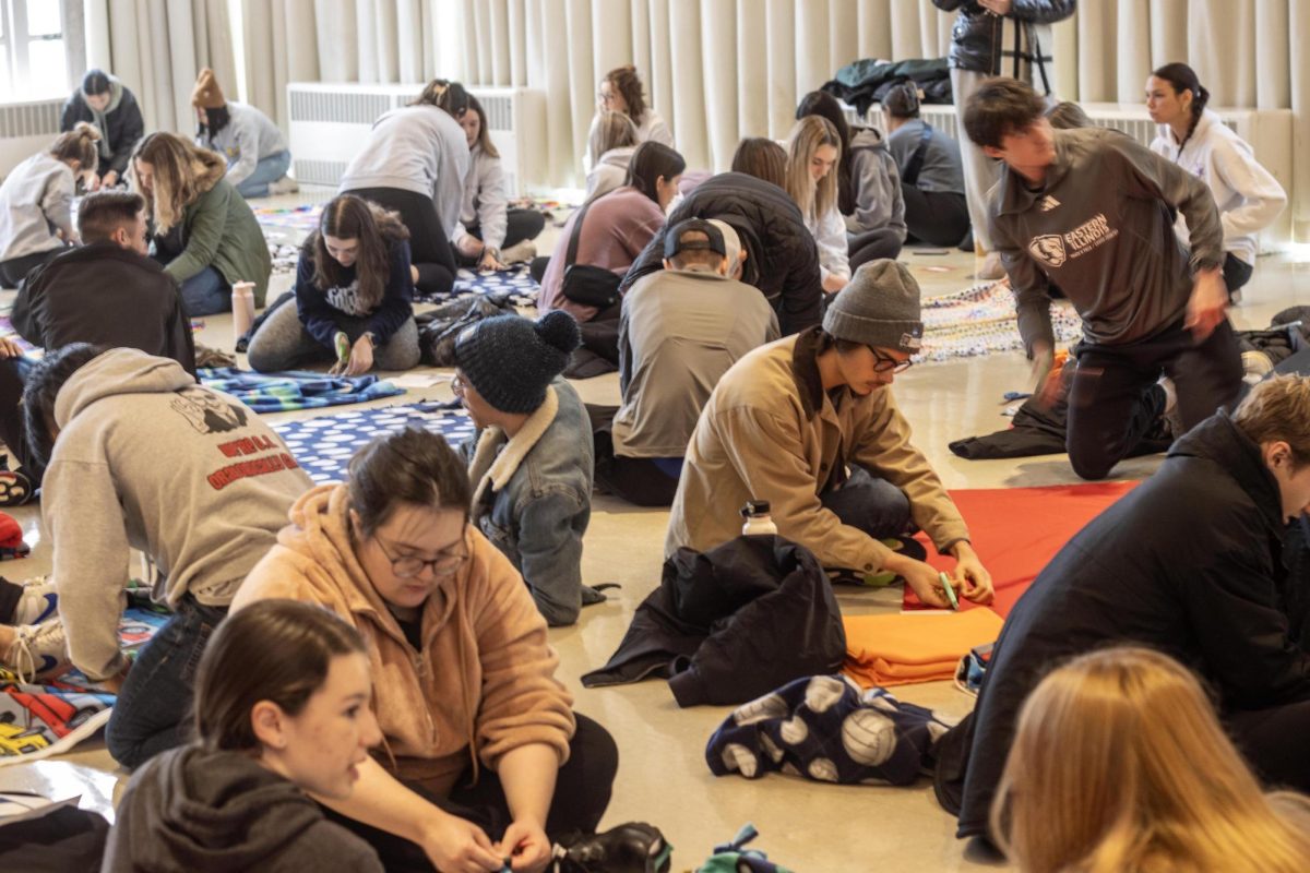 Students make blankets in the University Ballroom for the MLK Day of Service. 