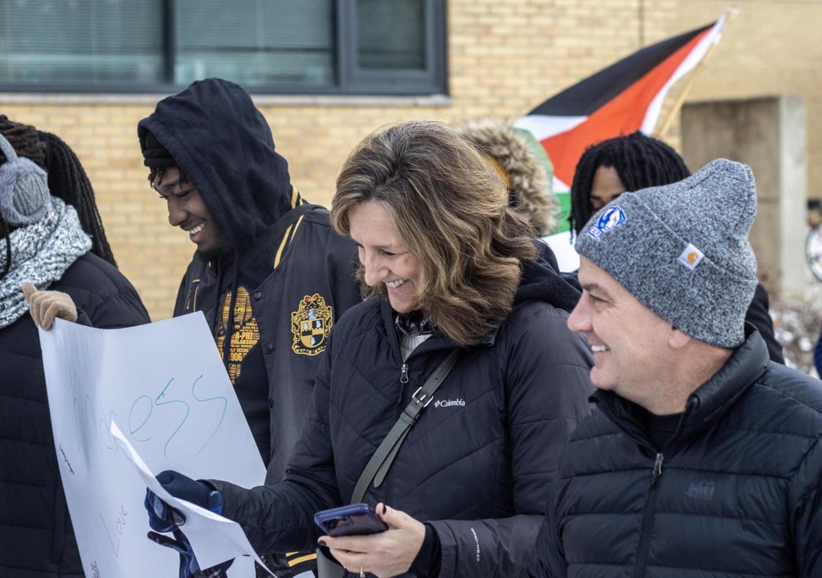 From left, Deshaun Streeter, sophomore construction management major, Vice President of Student Affairs Anne Flaherty and Eastern University President Jay Gatrell march in Martin Luther King Jr. vigil held by Alpha Phi Alpha Fraternity Inc. at Thomas Hall.