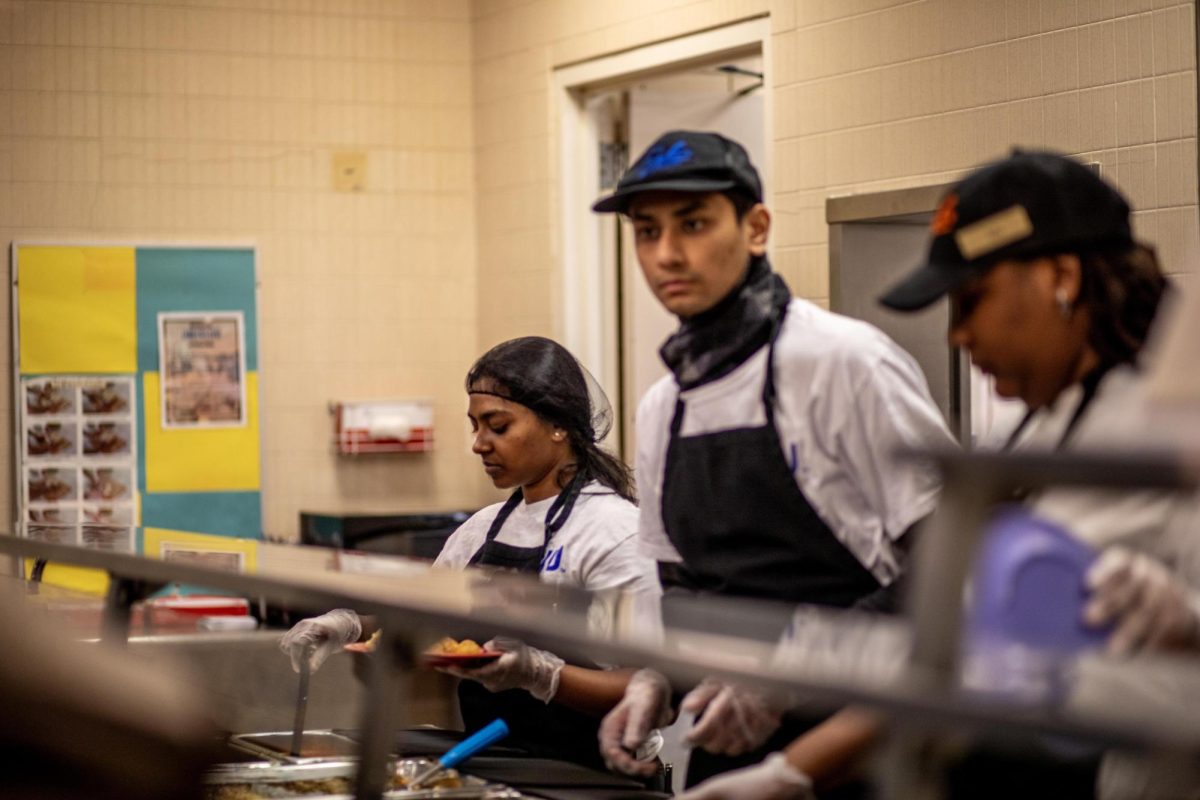 From right, Jyla Brown, a criminolgy major, Kaustuv Rayamajhi, a business analytics and information systems major, Chandana Pamba, a computer technology major, (left,) working the South Quad dining rush Monday night. 