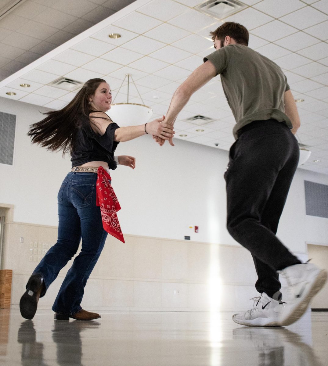 From left, Faith Hartke and Gabriel McElroy practice dancing together to music before the Panther Ho-Down event hosted by the Underground Line Dancing club starts on Saturday afternoon in the University Ballroom.
