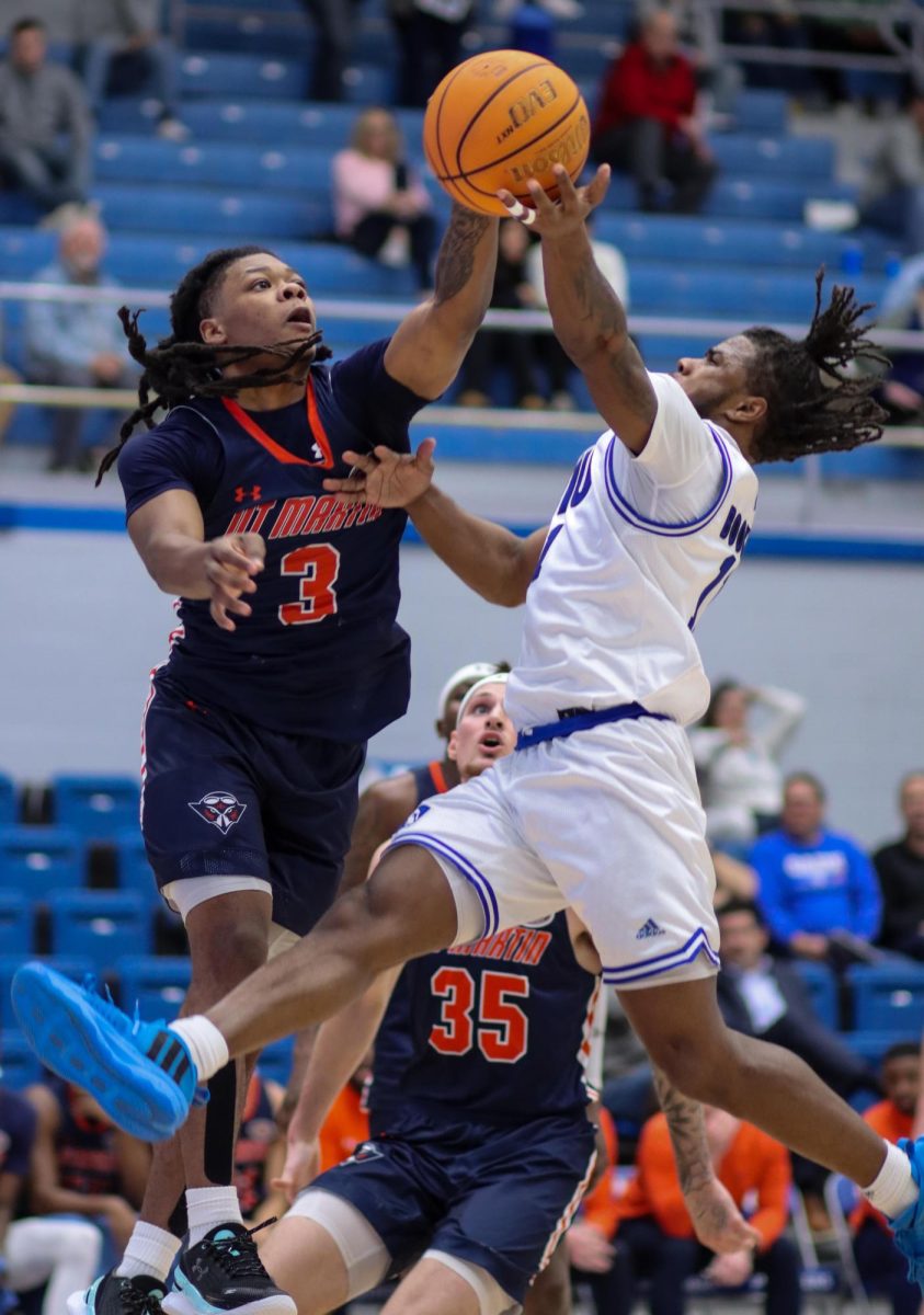 Eastern’s senior guard Tiger Booker shoots a contested layup over University of Tennessee-Martin’s junior guard Jordan Sears. The Panthers lost to the Skyhawks 76-59 Thursday evening in Groniger Arena.