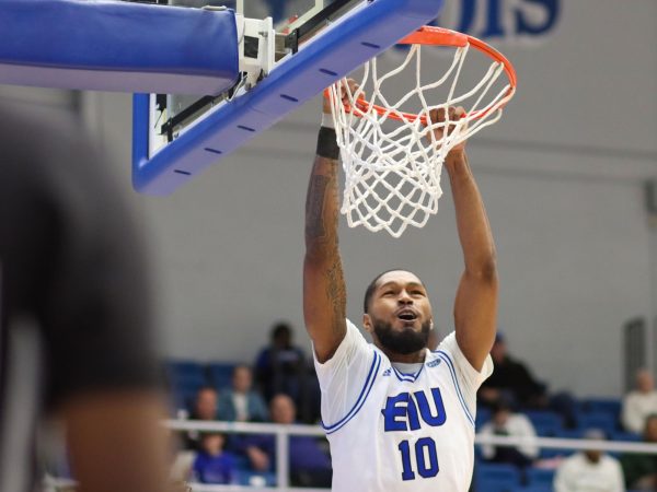 Junior guard/forward Kyndall Davis hangs onto the rim in Groniger Arena. The Panthers beat the Southeast Missouri State Redhawks 72-57 Thursday evening in Groniger Arena.