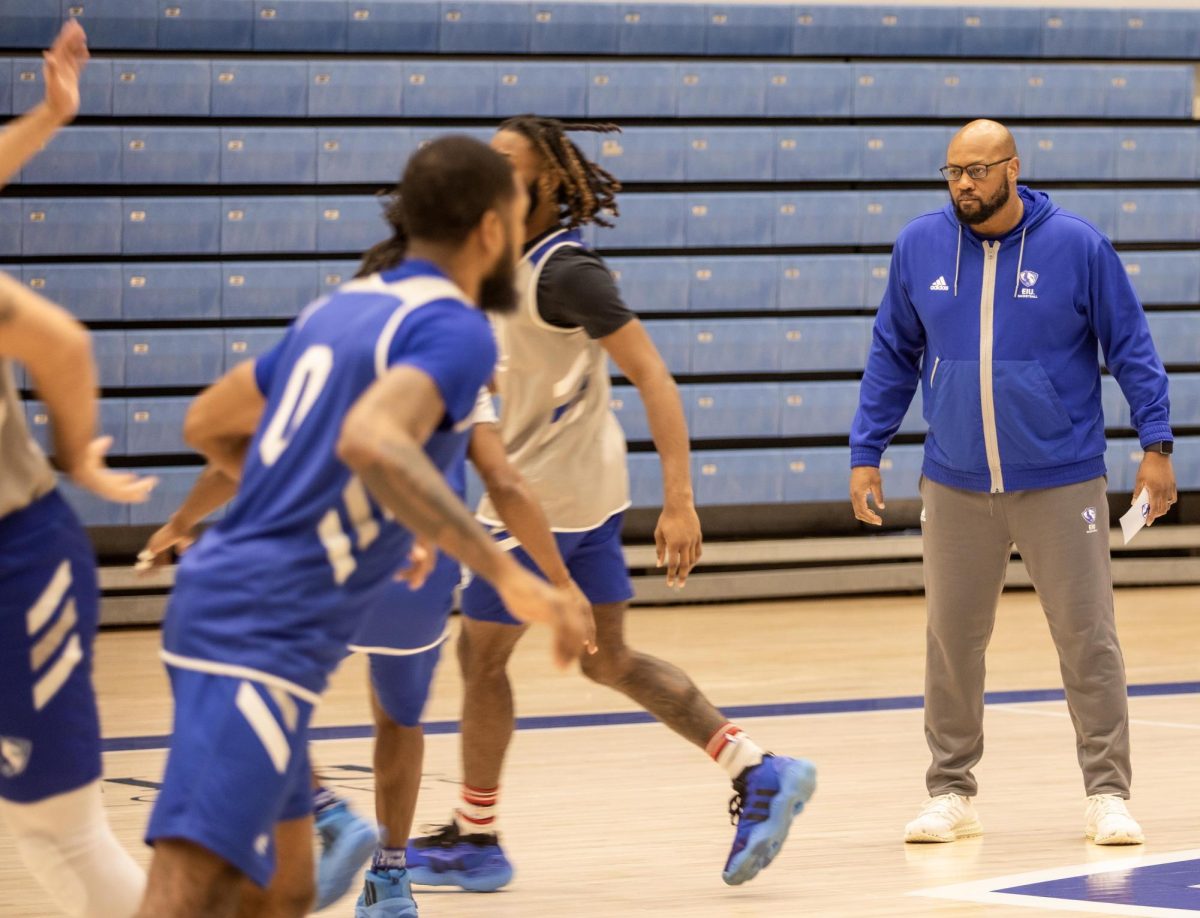 Assistant coach Marlon London making calls for basketball practice in Groniger Arena, Eastern Illinois University.  
