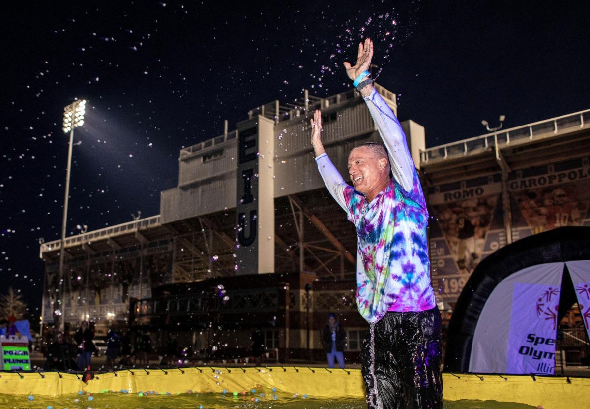 Provost Ryan Hendrickson celebrates after jumping into the pool of water during the Special Olympics Polar Plunge Sunday evening.