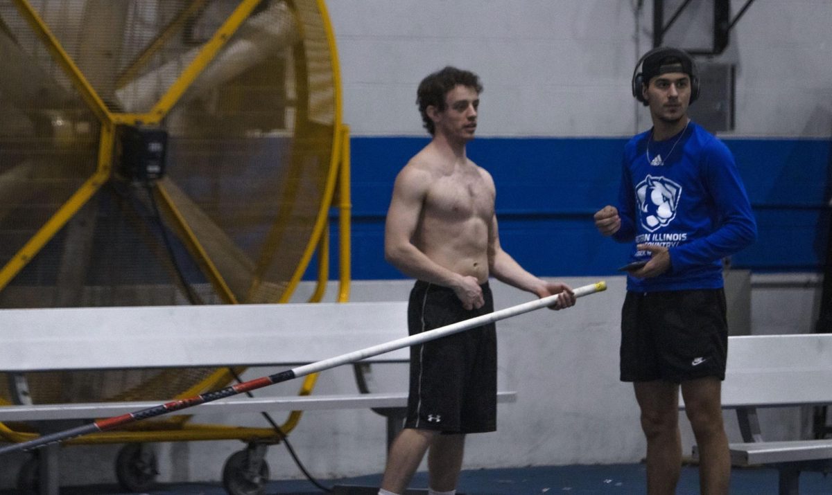Graduate pole vaulter Joseph Fisher and freshman Paul Mallinas practices in the Lantz Indoor Fieldhouse on Thursday afternoon, 