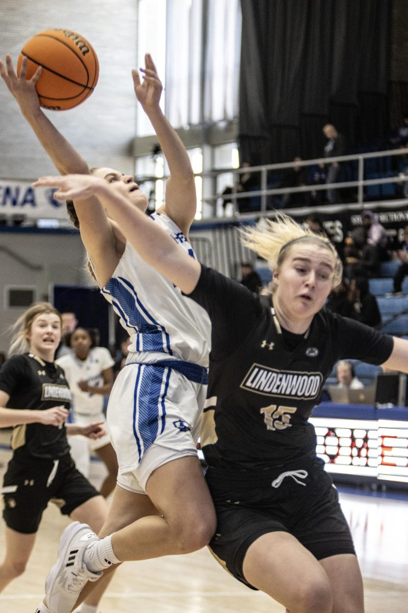 At Eastern Illinois Universitys basketball game against Lindenwood, guard Ellie Buzzelle goes up for a layup over forward Alyssa Nielsen at Groniger Arena Saturday afternoon. The Panthers won 68-62 against the Lions on Eastern Illinois Universitys campus 