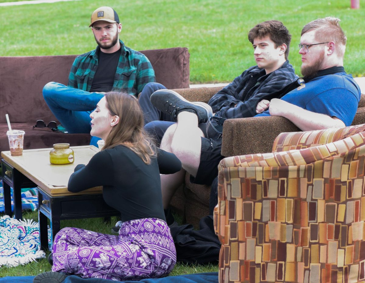 Christian Campus House students had a couch story time open talk about god. Emily Thorpe, a senior music major (front), Harrison Walker, a graduate student in cybersecurity (front right), Ashton Fifield, junior philosophy major (left on couch), and Gabriel McElroy, sophomore, sit in the South Quad Wednesday.