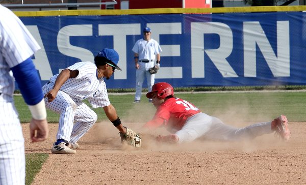 Junior infielder Danny Infante tags University of Dayton freshman infielder David Mendez during their double header on March 16 and 17 at Coaches Stadium