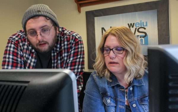 Senior radio and audio production major Aidan Grady (left) and WEIU News Director Kelly Goodwin (right)  discuss the preliminary details for an upcoming story.