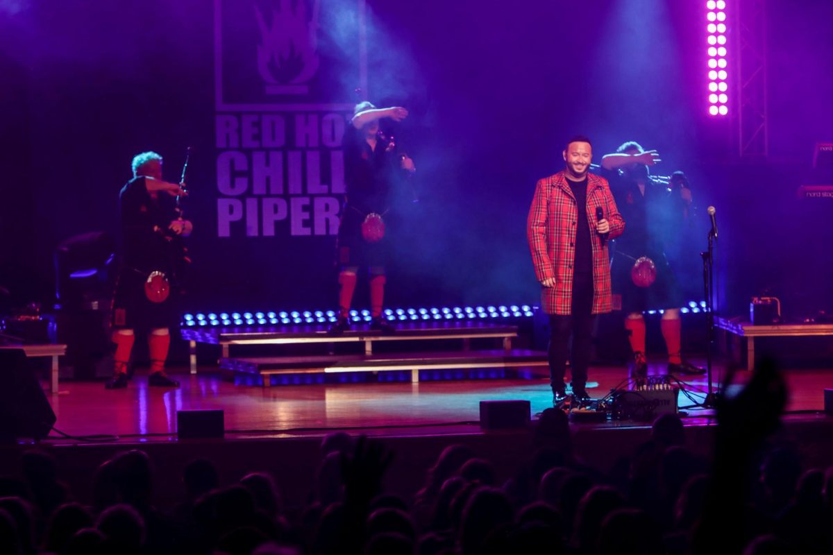 From left, bagpipers Willie Armstrong, Andrew Brodie, lead singer Chris Judge, and bagpipers Ross Miller get the audience to sway their hands from side to side during the Red Hot Chilli Pipers performance held in the Dvorak Concert Hall Saturday. 